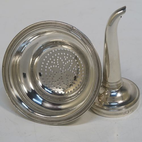A very handsome Antique Georgian Sterling Silver wine decanting funnel, having a plain round body with an applied double feather-edged border and a cast shell style side clip, and original removable funnel. This elegant antique silver wine funnel was made in London in 1819. The dimensions of this fine hand-made antique silver wine decanting funnel are height 13 cms (5 inches), diameter of bowl 9.5 cms (3.75 inches), and it weighs approx. 102g (3.3 troy ounces).