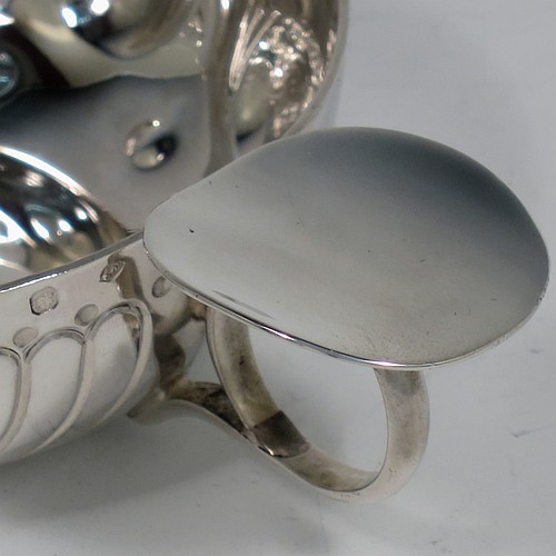 An Antique Victorian Silver French wine taster, having a round body, with hand-chased swirl-fluted and dimple decoration, a loop handle with plain thumb-piece, and sitting on a concave base with nine hand-chased beads running around the inside. Made in Paris, France ca. 1890, with a Minerva 1st Quality mark, indicating 950 standard silver. The dimensions of this fine hand-made antique silver wine taster or testavine are diameter 8 cms (3 inches), and height 3 cms (1.3 inch), and it weighs approx. 100g (3.2 troy ounces).    