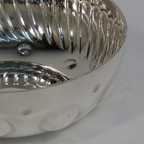 An Antique Victorian Silver French wine taster, having a round body, with hand-chased swirl-fluted and dimple decoration, a loop handle with plain thumb-piece, and sitting on a concave base with nine hand-chased beads running around the inside. Made in Paris, France ca. 1890, with a Minerva 1st Quality mark, indicating 950 standard silver. The dimensions of this fine hand-made antique silver wine taster or testavine are diameter 8 cms (3 inches), and height 3 cms (1.3 inch), and it weighs approx. 100g (3.2 troy ounces).    