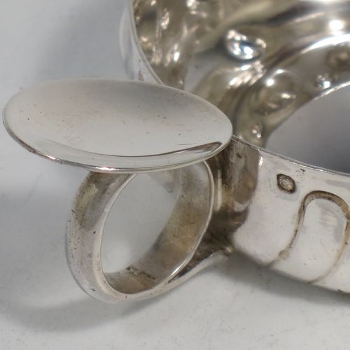 A pretty Antique Victorian Silver French testavine or wine taster, having a round body, with hand-chased bead and swirl-fluted decoration, a loop handle with thumb-piece, and sitting on a concave base. Made in Paris, France ca. 1890, with a Minerva 1st Quality mark, indicating 950 standard silver. The dimensions of this fine hand-made antique silver wine taster or testavine are diameter 7 cms (2.75 inches), and height 3 cms (1.3 inch), and it weighs approx. 72g (2.3 troy ounces).   