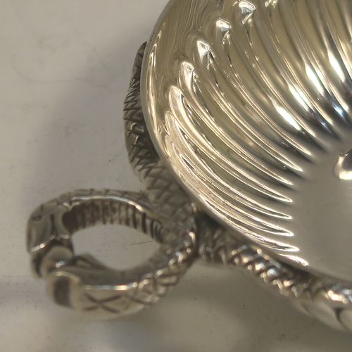A very elegant Sterling Silver tasse de vin or wine taster, having a round body with hand-chased fluted decoration, an applied cast snake head loop handle, and sitting on a flat base. Made by John Henry Odell of London in 1969. The dimensions of this fine hand-made silver wine taster or testavine are diameter 9 cms (3.5 inches), and height 2.5 cms (1 inch), and it weighs approx. 93g (3 troy ounces).  