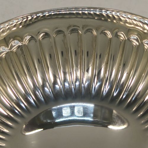 A very elegant Sterling Silver tasse de vin or wine taster, having a round body with hand-chased fluted decoration, an applied cast snake head loop handle, and sitting on a flat base. Made by John Henry Odell of London in 1969. The dimensions of this fine hand-made silver wine taster or testavine are diameter 9 cms (3.5 inches), and height 2.5 cms (1 inch), and it weighs approx. 93g (3 troy ounces).  